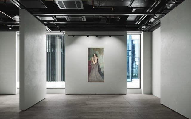 One tall panel in a dark concrete room between two partition walls.