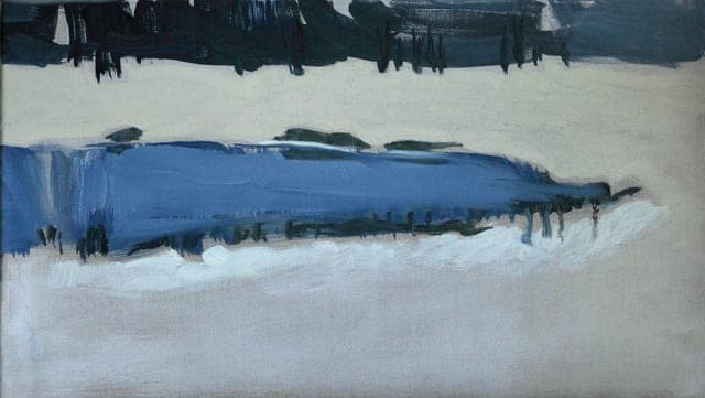 A pale, snow-lit field beneath a dark treeline — a horizontal landscape.